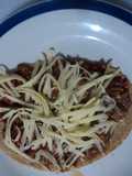 Huarache  asado de birria de pollo adobada al tequila con queso tipo San Diego.  Jalisco México