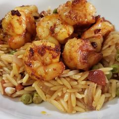 A picture of Orzo pasta with shrimp.