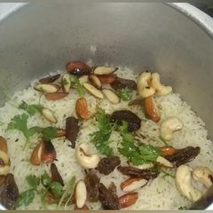 A picture of Birayani  With  Dry  Fruits  In  Pressure Cooker.
