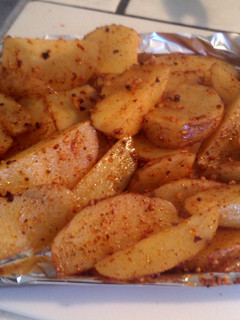 A picture of seasoned potato wedges.