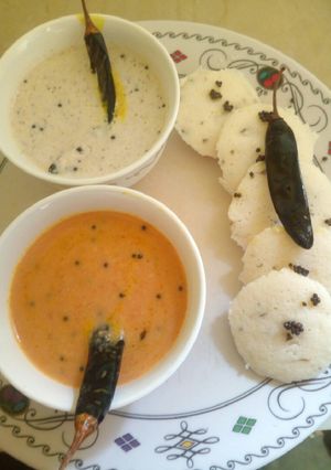 A picture of Rice idli with coconut chutney & tomato-onion chutney.
