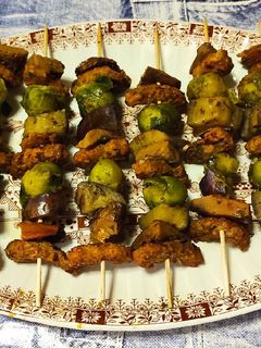 Una foto de Brochetas de bocaditos braseados, rovellones, berenjena y coles Bruselas con majao ajo y perejil