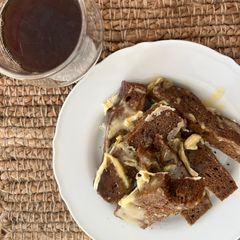A picture of Rye bread with brie and honey.