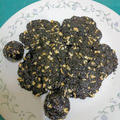 Black Sesame Seeds & Cashews Chikki Roundels A picture of Black Sesame Seeds & Cashews Chikki Roundels.