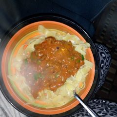 A picture of Pasta served with beef curry.