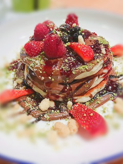 A picture of Wheat flour pancakes with maple syrup and some chocolate dip.