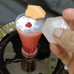 A picture of Rose melon Shake with coconut and sabja.