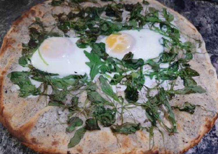 Pizza con rúcula y canónigos, queso trufa y huevo