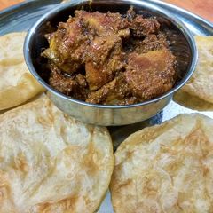 Luchi and kosha mangsho (chicken) A picture of Luchi and kosha mangsho (chicken).