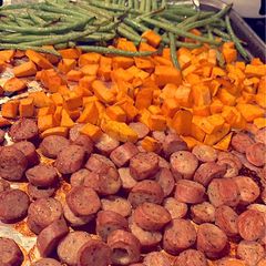 A picture of Roasted chicken sausage, sweet potatoes, and fresh green beans.