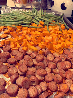A picture of Roasted chicken sausage, sweet potatoes, and fresh green beans.