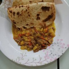 A picture of Arabian Khubz with beef and potato soup.
