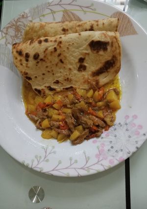 A picture of Arabian Khubz with beef and potato soup.