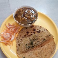 A picture of Pindi chola and bread crumbs paratha.