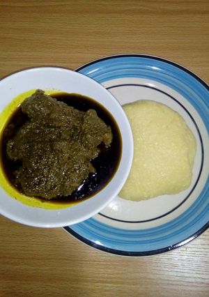 A picture of Black soup with garri.