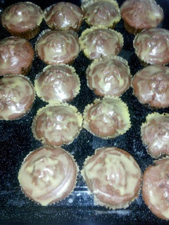 A picture of Red and green velvet cupcakes with fudge icing.