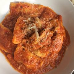 A picture of Lockdown butternut squash and ricotta ravioli, with tomato sauce.