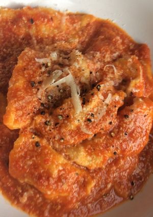 A picture of Lockdown butternut squash and ricotta ravioli, with tomato sauce.