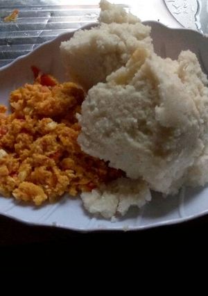 A picture of Fried eggs served with Ugali.