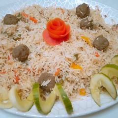 A picture of Fried rice with meat balls.