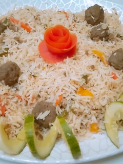 A picture of Fried rice with meat balls.
