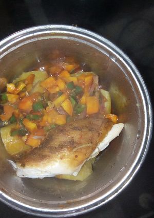 A picture of Boiled Plantain garnished with veggie sauce and chicken.