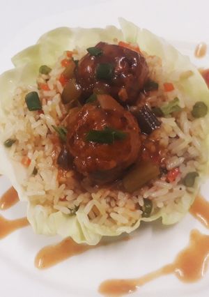 A picture of Fried rice with veg manchurian.