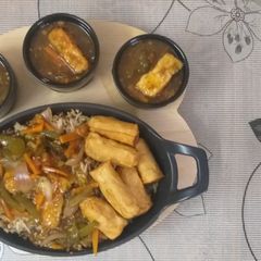 A picture of Sizzling chilli paneer with fried rice.
