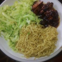 A picture of Noodles, chicken and cabbage.