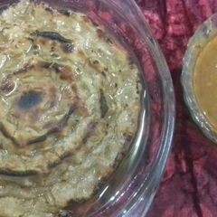 A picture of Rote with spicy aloo gravy.