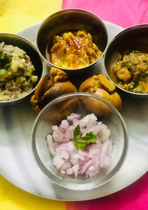 A picture of Exotic Sattu Bati with lavish Tamatar and Aloo Chokha And Masala Dal.