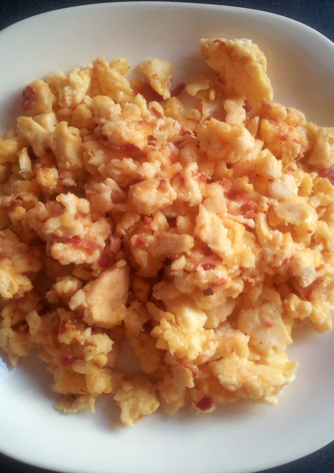 A picture of Scrambled eggs with bacon.
