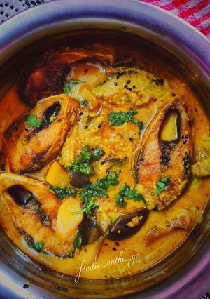A picture of Hilsa fish cooked with aubergine in a mustard gravy.
