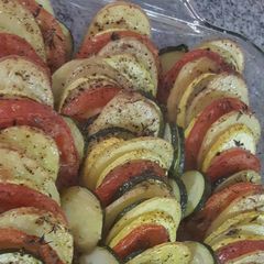 A picture of Baked potato,zucchini,yellow squash,tomato.