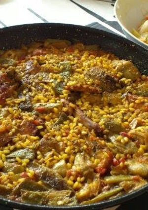 A picture of Valencian Paella with Chicken and Rabbit.