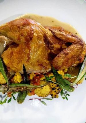 A picture of Grilled chicken with corn.