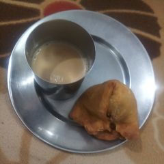 A picture of Aaloo samosa with tea.
