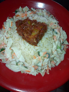 A picture of White rice and salad and Stew chicken.