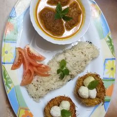 A picture of Ghiya paneer malai kofta with nest and jeera rice.