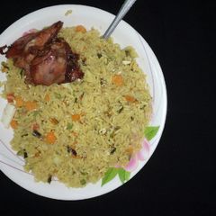 A picture of Fried rice with fried chicken.