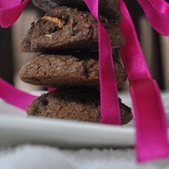 A picture of Chocolate cookies with nuts and white chocolate chunks.