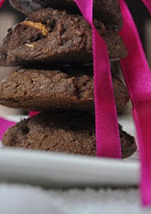 A picture of Chocolate cookies with nuts and white chocolate chunks.