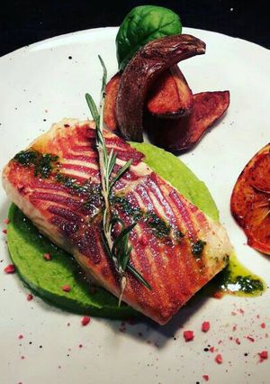 A picture of Grilled Salmon on mashed peas.