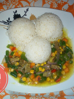 A picture of White rice and veggies beef sauce.