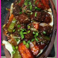A picture of Paneer chilly manchurian with sizzling.