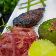A picture of Pan-fried Chicken with Hara Bhara Kebab, Asparagus & Laccha onion.