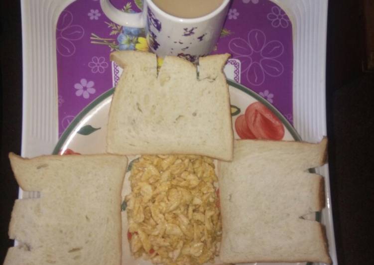 Scrambled eggs and sliced bread with cowbell coffee drink