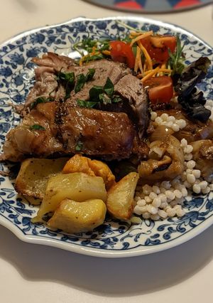 A picture of Roasted Lamb shoulder with giant Couscous & caramelised onions.
