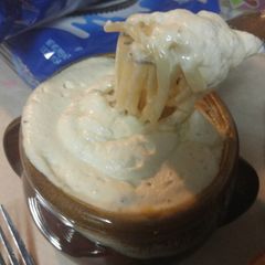 A picture of Noodle soup with cream sauce.