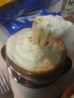 A picture of Noodle soup with cream sauce.